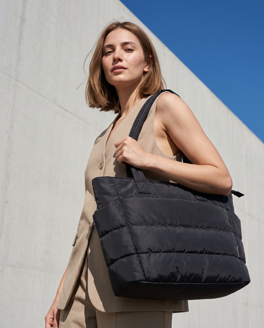 VELÁ Puffer Tote in Black on the shoulder